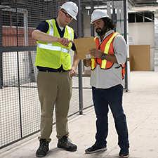 Two men looking at a clipboard