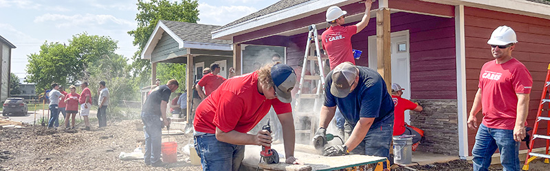 A large group of MidAmerican employees at work constructing homes as part of a volunteer event in South Dakota