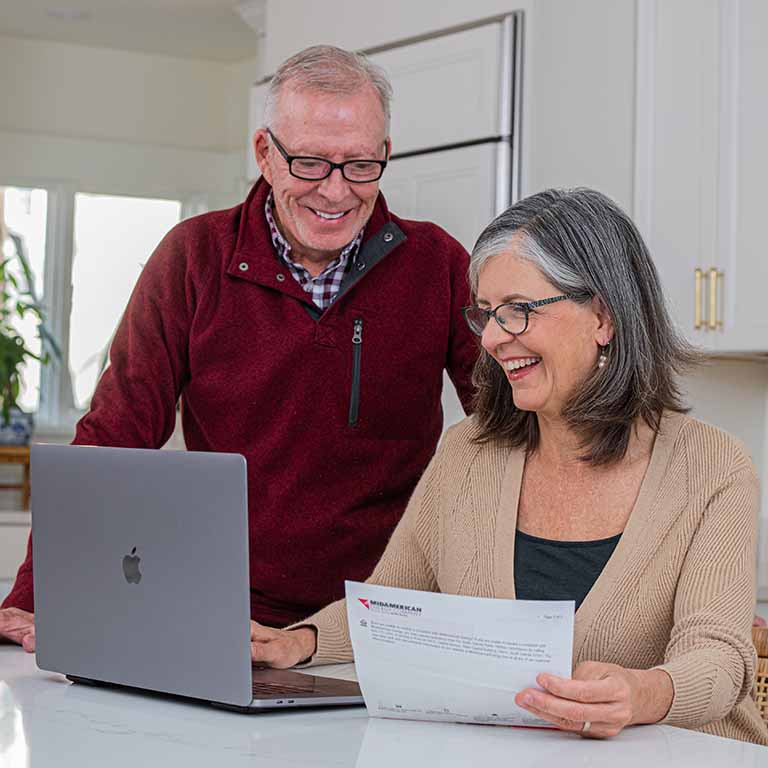 Older couple at a laptop with their bill