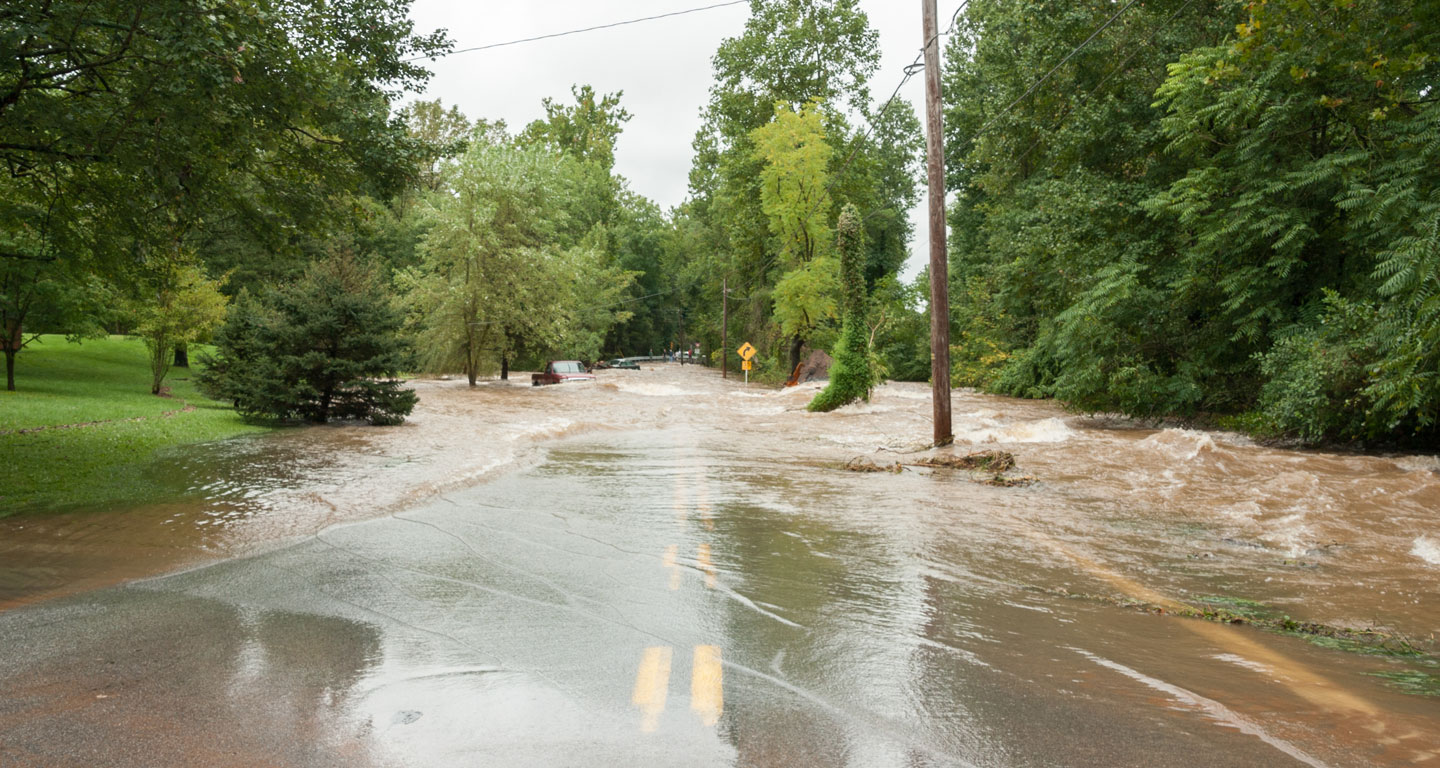 Flooded road with a partially submerged pick-up truck