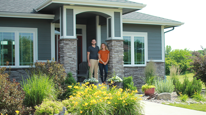 Couple looks out from front porch