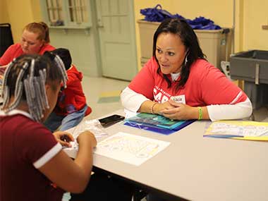 Two MidAmerican employees volunteering in a classroom