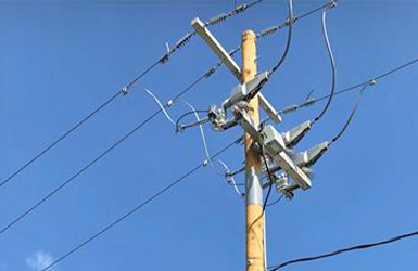 Remote switches installed on powerlines, mounted high on a utility pole