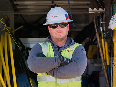 Front-line worker wearing safety vest and hardhat