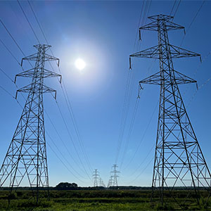 High-voltage transmission towers and power lines extending into the distance