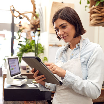 women store owner working on a laptop