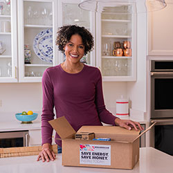 women standing next to the EE Kit box