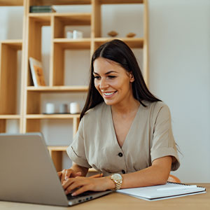 Women at a table in a home on a computer