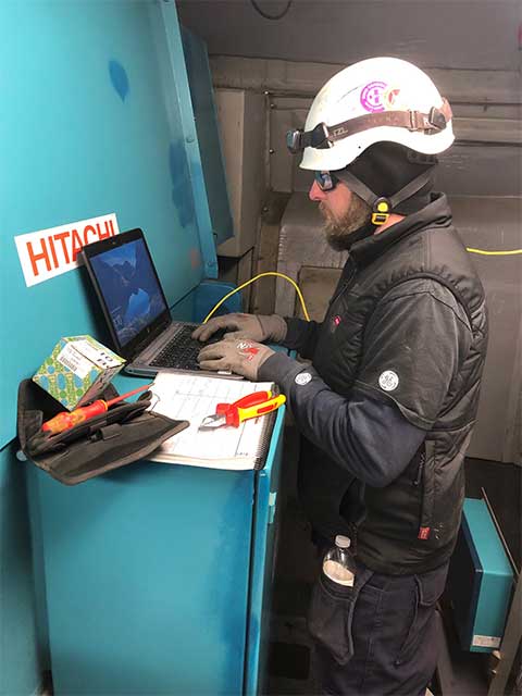 Jason Gruszeczka standing fixing a wind turbine