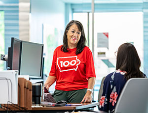 MidAmerican employees talking at a desk