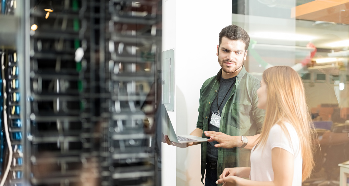 Technicians reviewing servers in a data center