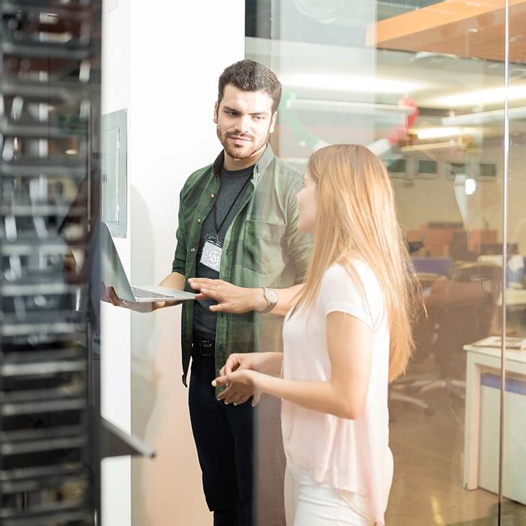 Technicians reviewing servers in a data center