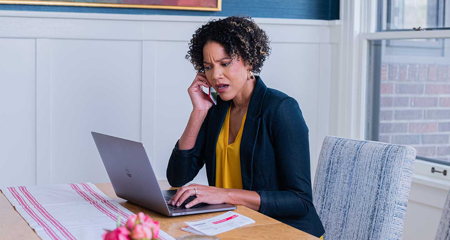 Black woman on phone looking alarmed