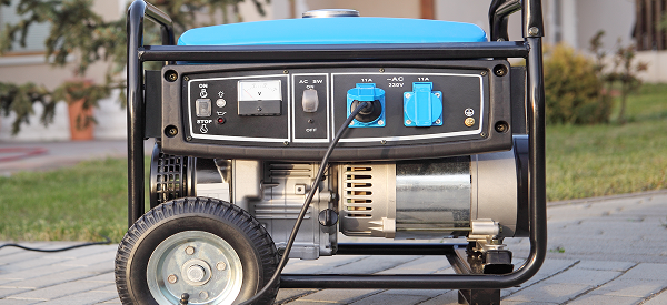 A portable generator sitting in a residential driveway