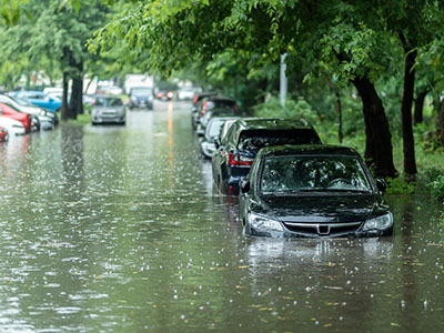 Flooded road with a line of partially-submerged vehicles