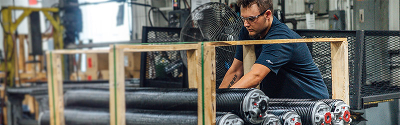 An employee of Iowa Spring readies springs to ship out to customers