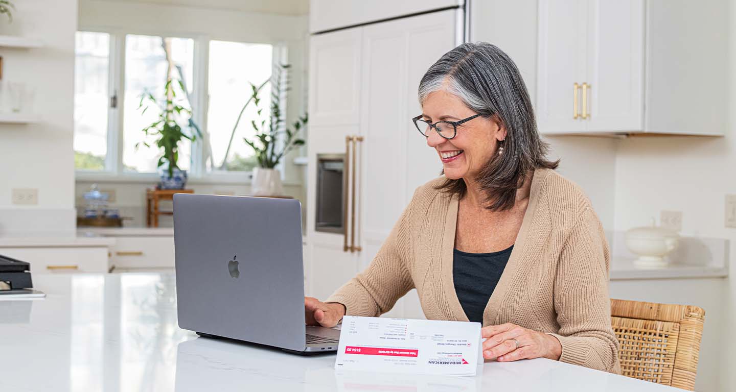 A middle-aged woman paying her bill from MidAmerican Energy - MidAmerican electric customers pay the fifth-lowest rates in the nation or lower
