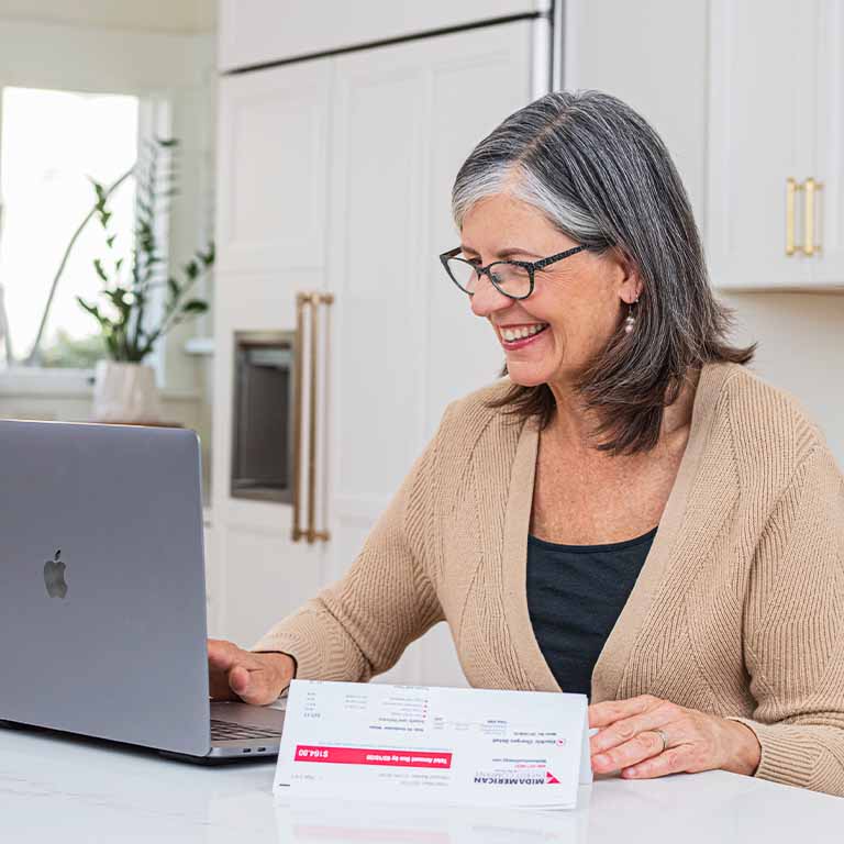 A middle-aged woman paying her bill from MidAmerican Energy - MidAmerican electric customers pay the fifth-lowest rates in the nation or lower