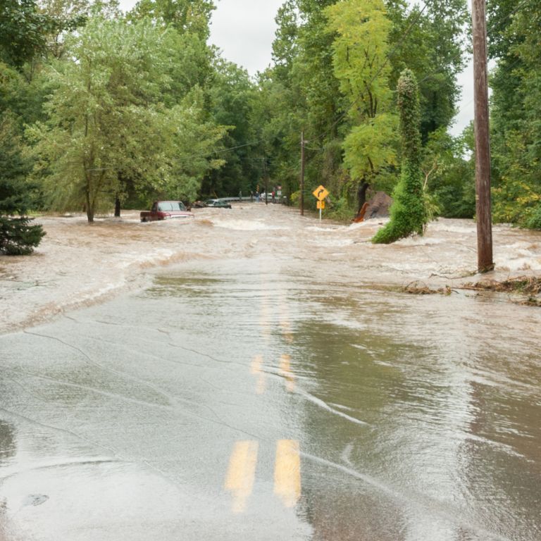 Flooded road with a partially submerged pick-up truck