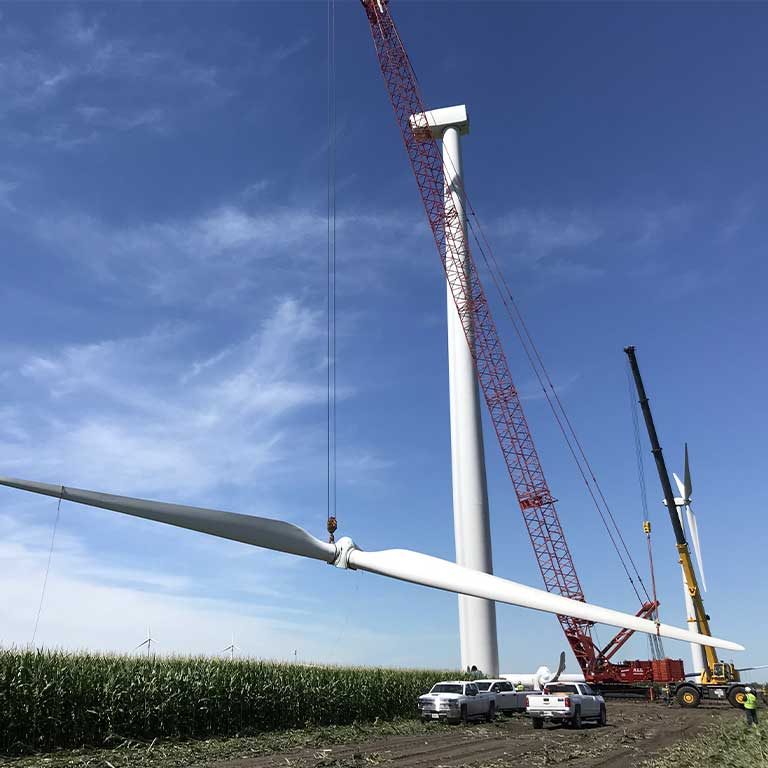 Red crane lifting wind turbine blade - mobile