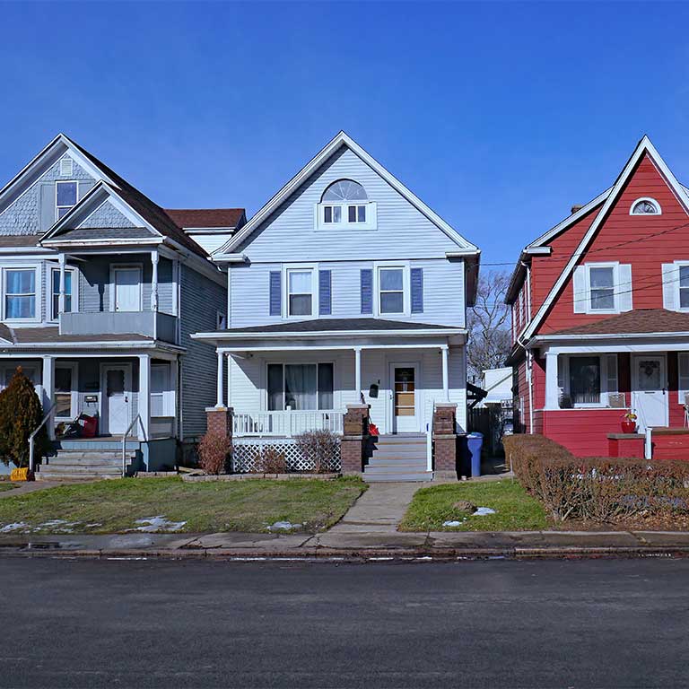 Three homes with pointed roofs
