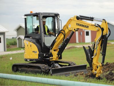 Gas employee operates digging equipment