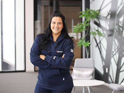 Female trainer faces camera smiling, Training Center