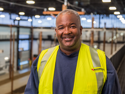 Lineman Ron B. smiles from up on the catwalk of our Adel training center