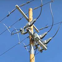 Remote switches installed on powerlines, mounted high on a utility pole