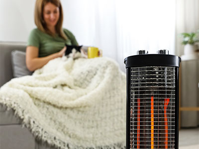 Space heater warming a room with a woman and her cat